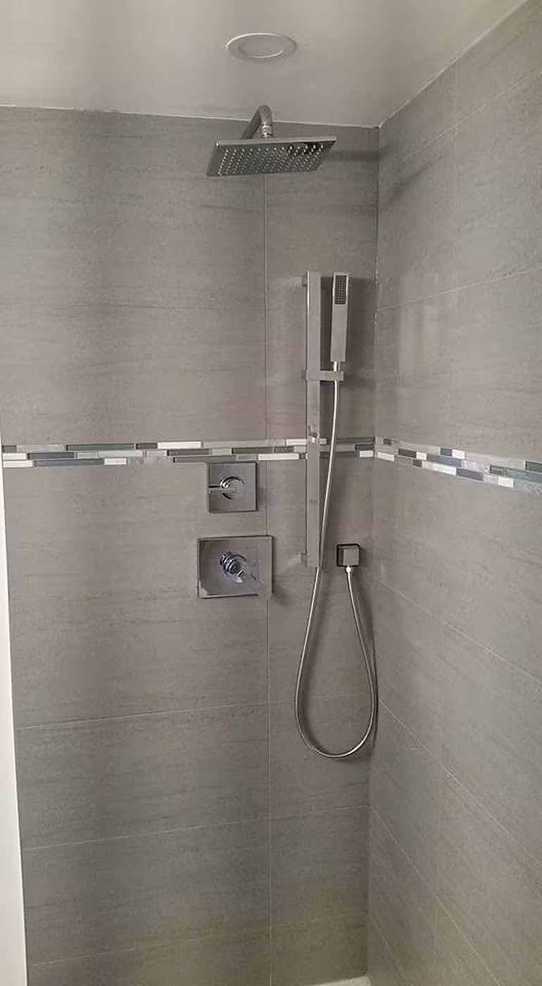 Rain Shower Installation — Custom rain head with wall-mount handset.