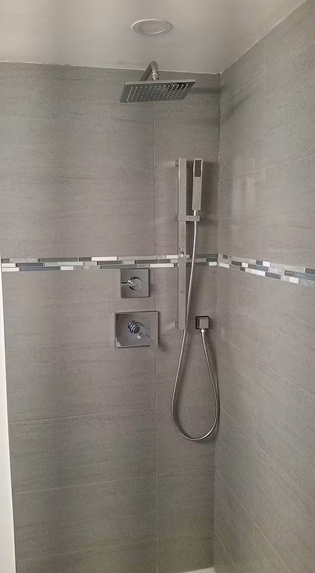 Rain Shower Installation — Custom rain head with wall-mount handset.