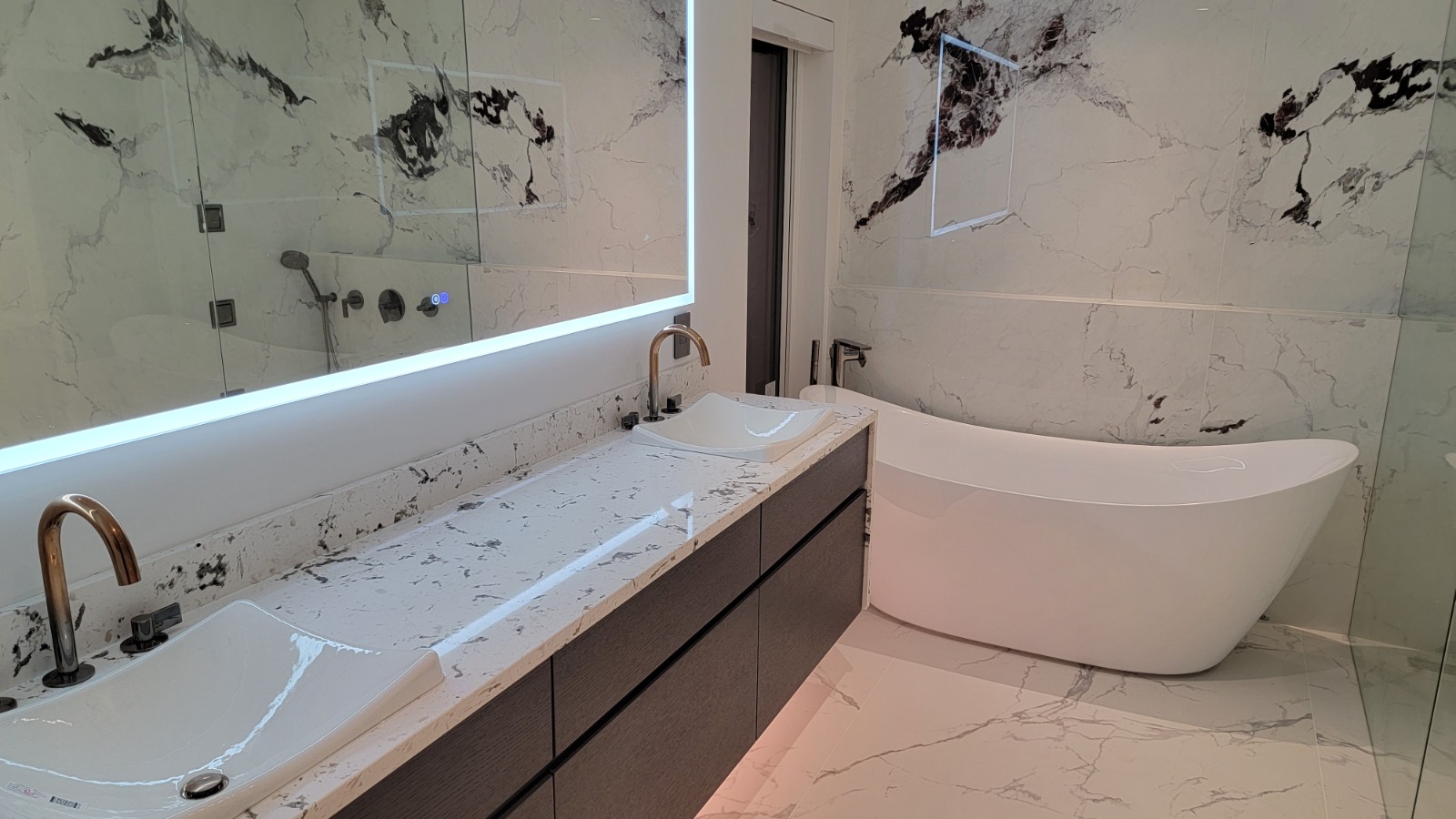 Residential Bathroom — New Build — Marble en-suite with double vanity and freestanding tub in a residential new build.